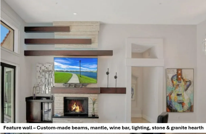 Feature wall with custom beams, mantle, wine bar, lighting, stone and granite hearth
